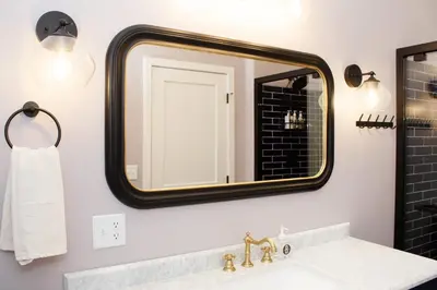 a bathroom with a sink and a large mirror at Bischoff Inn - Former 1870 Furniture Factory Now 5 Room Boutique Hotel in Tamaqua
