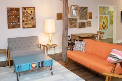 a living room with a couch and a table at Bischoff Inn - Former 1870 Furniture Factory Now 5 Room Boutique Hotel in Tamaqua