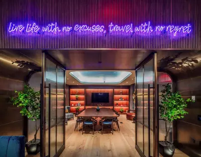 a dining room with a table and a purple sign at Tempo By Hilton New York Times Square in New York