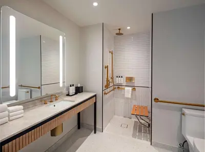 a bathroom with a sink and a shower and a toilet at Tempo By Hilton New York Times Square in New York