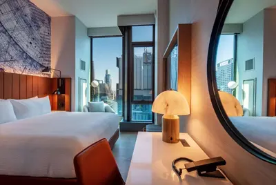 a hotel room with two beds and a mirror at Tempo By Hilton New York Times Square in New York