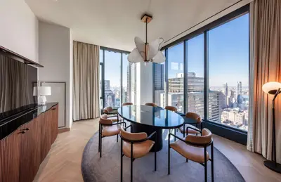 a dining room with a table and chairs and a large window at Tempo By Hilton New York Times Square in New York