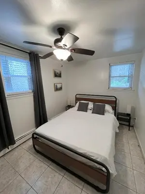 a bedroom with a bed and a ceiling fan at Two Bedroom Private Apt near NYC in West New York