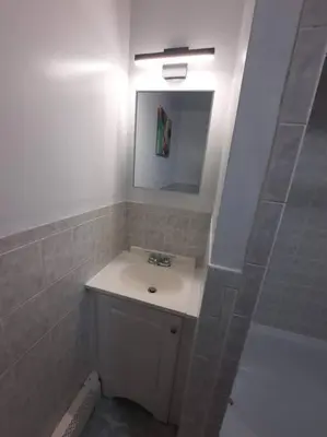 a bathroom with a sink and a mirror at Two Bedroom Private Apt near NYC in West New York