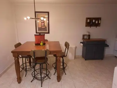 a kitchen with a wooden table and chairs at Two Bedroom Private Apt near NYC in West New York