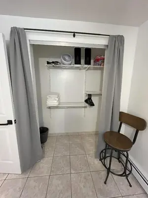 a room with a chair and a door with a curtain at Two Bedroom Private Apt near NYC in West New York
