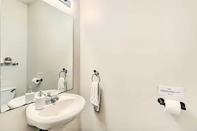 a white bathroom with a sink and a mirror at Game Room Poconos Family Home 13 Mi to Skiing! in Tobyhanna