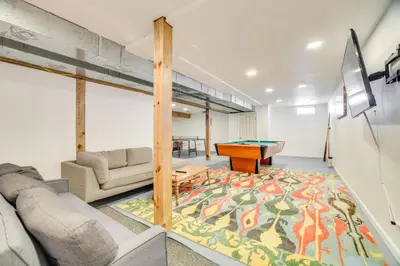 a living room with a couch and a pool table at Game Room Poconos Family Home 13 Mi to Skiing! in Tobyhanna