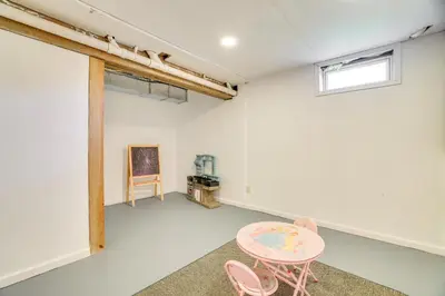 a room with a table and two pink chairs at Game Room Poconos Family Home 13 Mi to Skiing! in Tobyhanna