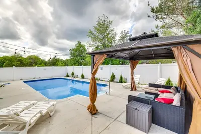 a patio with a pool and an umbrella at Game Room Poconos Family Home 13 Mi to Skiing! in Tobyhanna