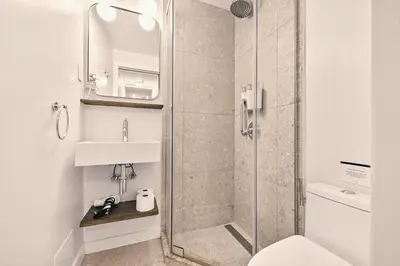a bathroom with a shower and a sink at Outsite Chelsea in New York