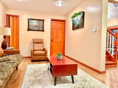 a living room with a couch and a coffee table at Chic Chalet River Views & Access in Montague