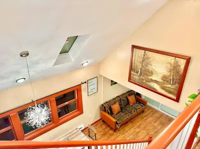 a living room with a couch and a window at Chic Chalet River Views & Access in Montague
