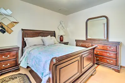 a bedroom with a bed with a dresser and a mirror at Hot Tub and Deck Pet-Friendly Poconos Getaway! in Bushkill