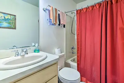 a bathroom with a sink and a red shower curtain at Hot Tub and Deck Pet-Friendly Poconos Getaway! in Bushkill