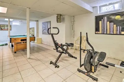 a room with a gym with a exercise bike and a desk at Hot Tub and Deck Pet-Friendly Poconos Getaway! in Bushkill