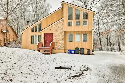 a house in the snow in the yard at Hot Tub and Deck Pet-Friendly Poconos Getaway! in Bushkill