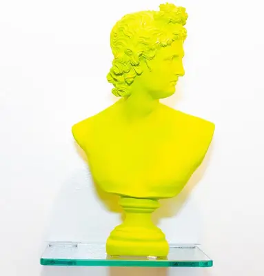 a yellow bust of a woman on a shelf at Art Deco Graffiti Suite in Philadelphia
