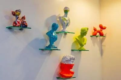 a group of glass figurines on display on a wall at Art Deco Graffiti Suite in Philadelphia