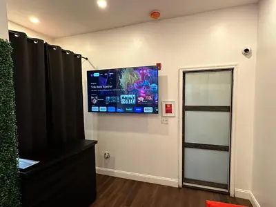 a room with a flat screen tv on a wall at Art Deco Graffiti Suite in Philadelphia