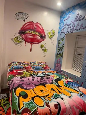 a bedroom with a bed with a mouth on the wall at Art Deco Graffiti Suite in Philadelphia