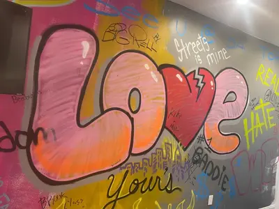 a wall covered in graffiti on a wall at Art Deco Graffiti Suite in Philadelphia
