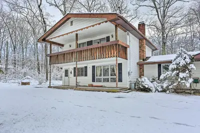 a house with snow on the ground in front of it at Large Greeley House with 2 Game Rooms and Yard! in Lackawaxen