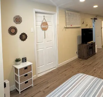 a bedroom with a bed and a white door at Classical Isbills Row House close to NYC in Bayonne