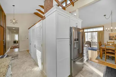a kitchen with white cabinets and a stainless steel refrigerator at Pocono Pines, Lake Naomi 4 bedrooms, 2 full bath in Pocono Pines