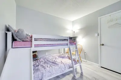 a small bedroom with two bunk beds in it at 8 Mi to Tobyhanna State Park Poconos Home! in Mushroom Farms