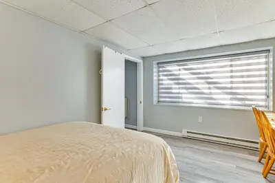 a bedroom with a bed and a large window at 8 Mi to Tobyhanna State Park Poconos Home! in Mushroom Farms