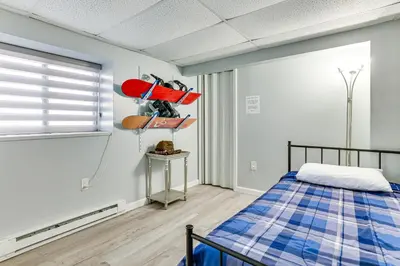 a bedroom with a bed and surfboards on the wall at 8 Mi to Tobyhanna State Park Poconos Home! in Mushroom Farms