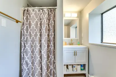 a bathroom with a shower curtain and a sink at 8 Mi to Tobyhanna State Park Poconos Home! in Mushroom Farms
