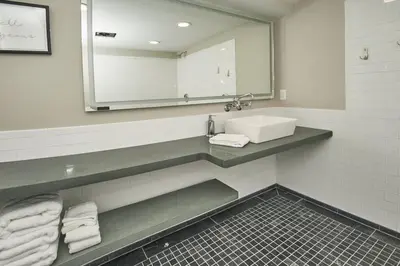 a bathroom with a sink and a mirror and towels at Craftsman Hideaway at the 1841 Farmhouse in Chester