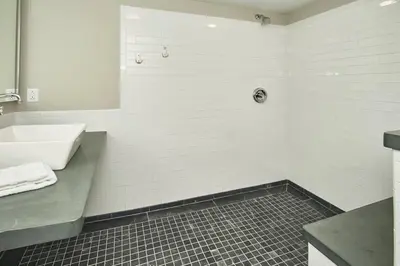 a white bathroom with a sink and a tub at Craftsman Hideaway at the 1841 Farmhouse in Chester