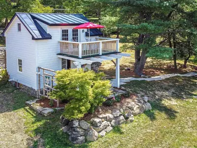 a house with a deck with a red roof at 1786 Farm Cottage Honeymoon Suite Renovated 2022 in Chester