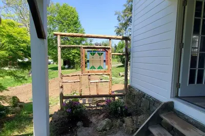 a window in a frame on the side of a house at 1786 Farm Cottage Honeymoon Suite Renovated 2022 in Chester