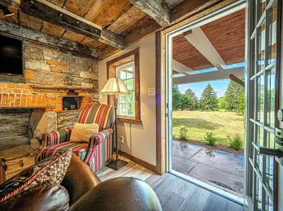 a living room with a couch and a window at 1786 Farm Cottage Honeymoon Suite Renovated 2022 in Chester