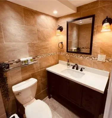 a bathroom with a toilet and a sink and a mirror at Cozy Apartments close to New York City in North Bergen