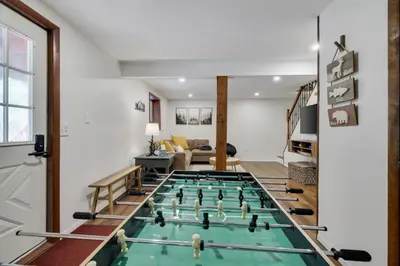 a house with a pool table in the middle of a living room at Camp Cedar:7 miles to Camelback, 5 to Kalahari! in Long Pond