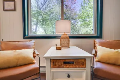 a room with two chairs and a table with a lamp at Camp Cedar:7 miles to Camelback, 5 to Kalahari! in Long Pond