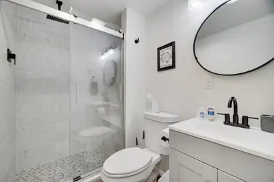 a bathroom with a shower and a toilet and a sink at Camp Cedar:7 miles to Camelback, 5 to Kalahari! in Long Pond