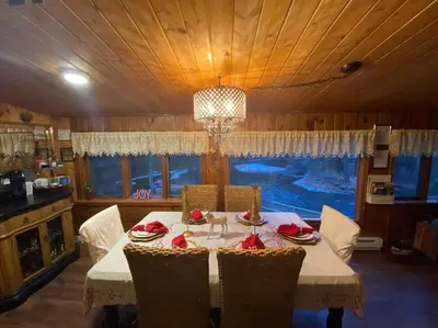 a dining room with a white table and chairs at Peaceful Gateway to Island Creek Cottage in East Stroudsburg
