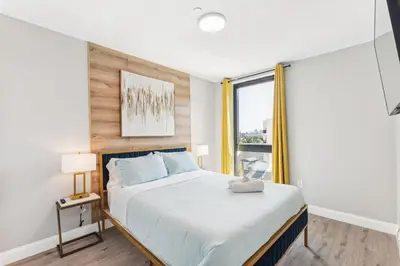 a bedroom with a large bed and a window at Stay at Luna on N 11th St in Philadelphia