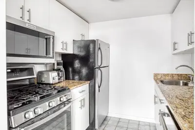 a kitchen with a stainless steel refrigerator and a sink at Tribeca Studio Indoor pool Great views NYC-185 in New York