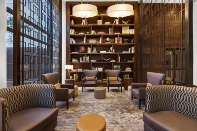 a waiting room with chairs and bookshelves at Tribeca Studio Indoor pool Great views NYC-185 in New York