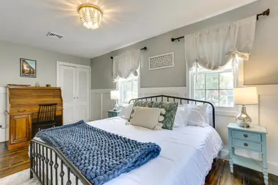 a bedroom with a large white bed with a blue blanket at Bright Cornwall-On-Hudson Vacation Rental! in Cornwall-on-Hudson