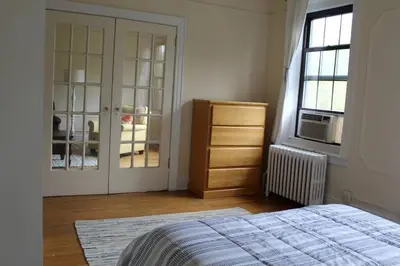 a bedroom with a bed and a dresser and a window at Fantastic stay for 4 – Heart of Hoboken! in Hoboken