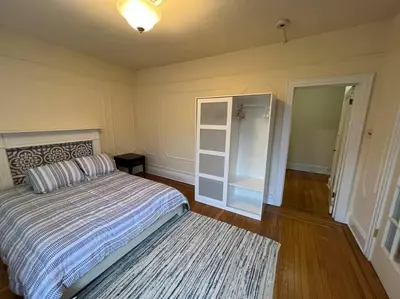 a bedroom with a bed and a door to a closet at Fantastic stay for 4 – Heart of Hoboken! in Hoboken