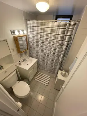 a bathroom with a toilet and a sink and a shower at Fantastic stay for 4 – Heart of Hoboken! in Hoboken